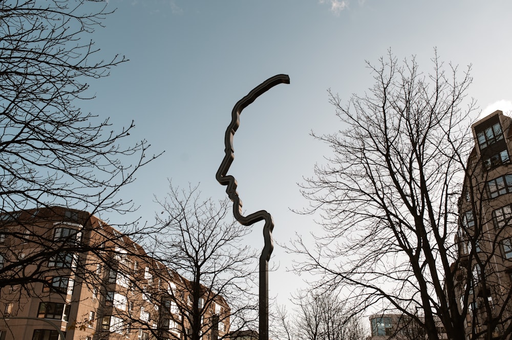 black and white street light near bare trees during daytime