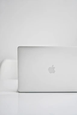 Close-up of a silver MacBook with a clean, modern aesthetic in monochrome tones