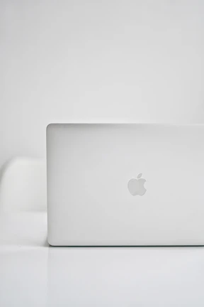 Sleek modern notebook with black and orange accents on a clean white background