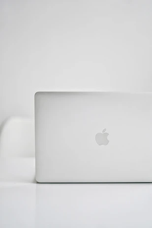 A sleek laptop and SSD displayed on a clean white surface with soft natural lighting.