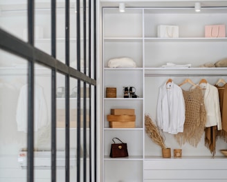 white bath towel on white wooden cabinet