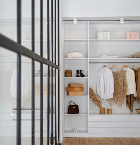 white bath towel on white wooden cabinet