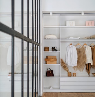 white bath towel on white wooden cabinet