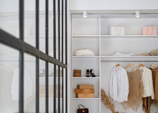 white bath towel on white wooden cabinet