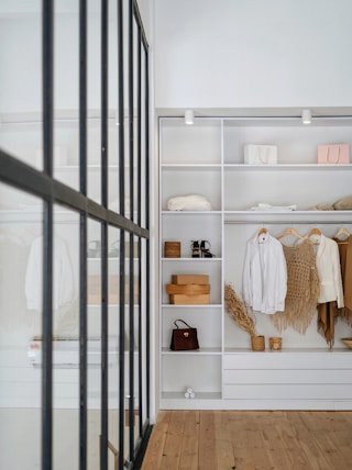 white bath towel on white wooden cabinet