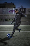 Dynamic shot of a grassroots footballer testing new boots during an intense training session.