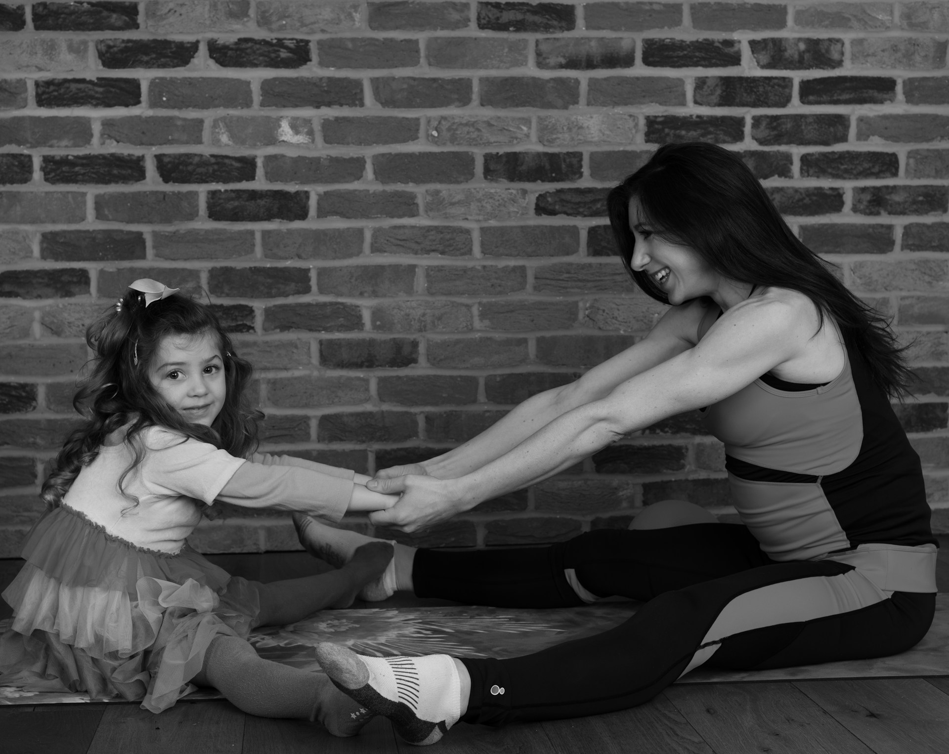 woman in white dress shirt and black skirt sitting on floor