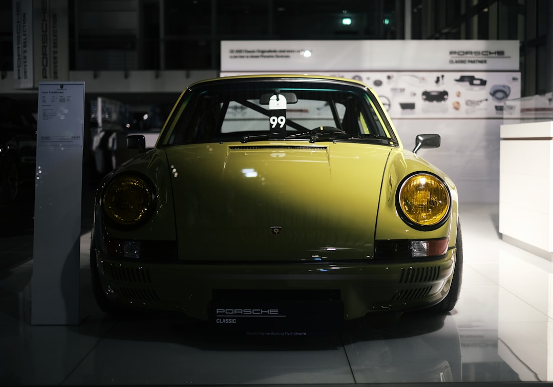 yellow porsche 911 parked in a parking lot