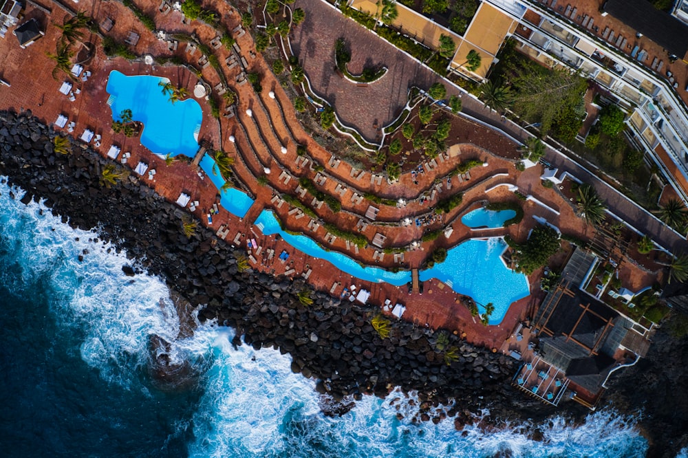 aerial view of red and blue building near body of water during daytime