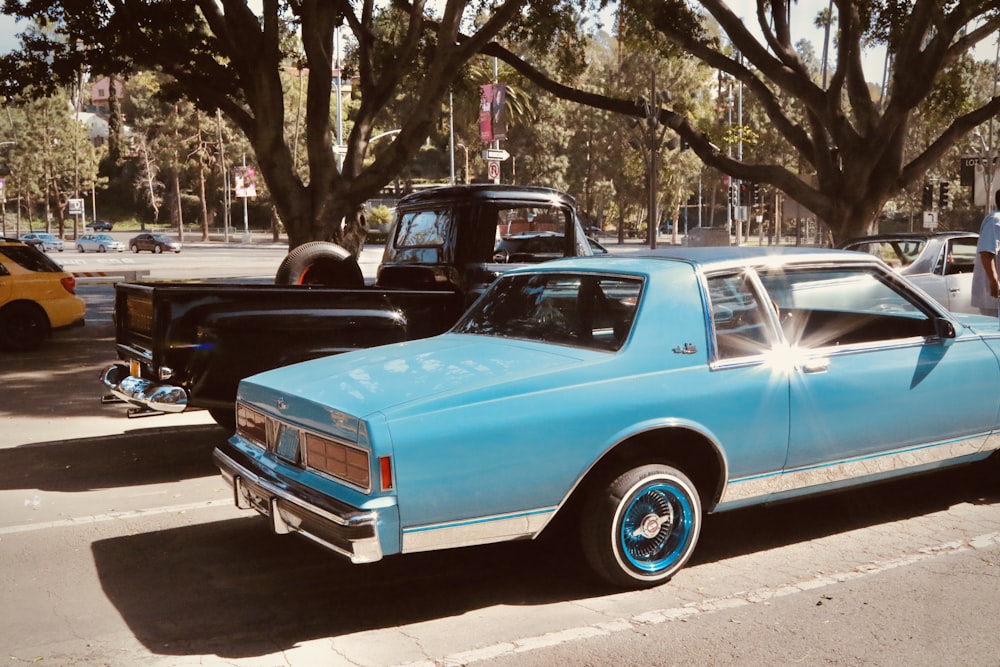 blue vintage car on road during daytime