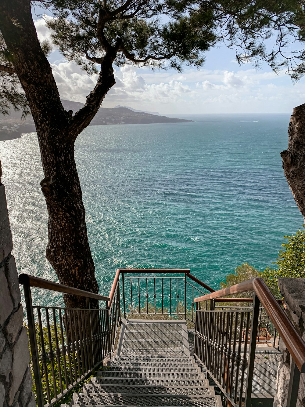 blue metal railings near body of water during daytime