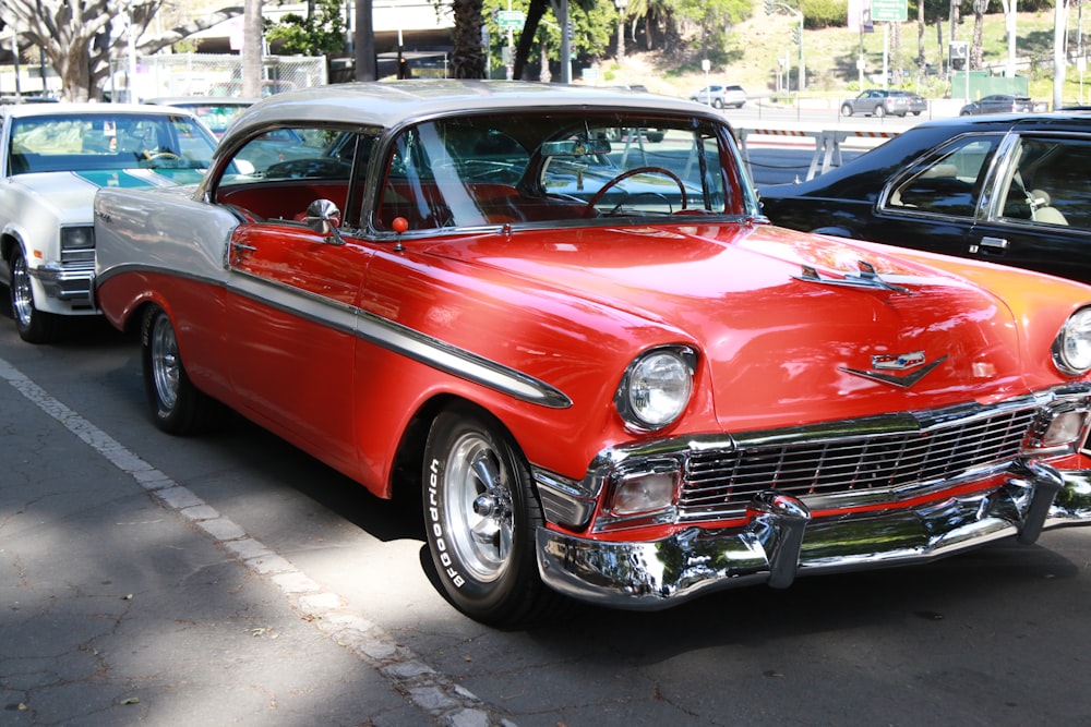 red classic car parked on parking lot during daytime