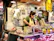 Happy female butcher checking inventory in a modern meat shop.