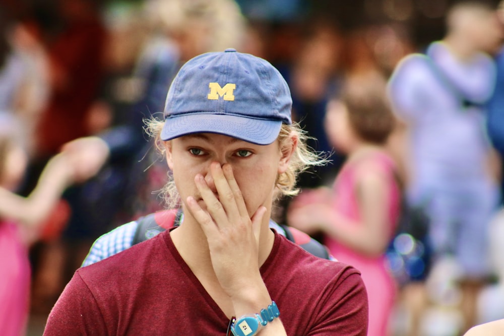 woman in red shirt wearing blue cap