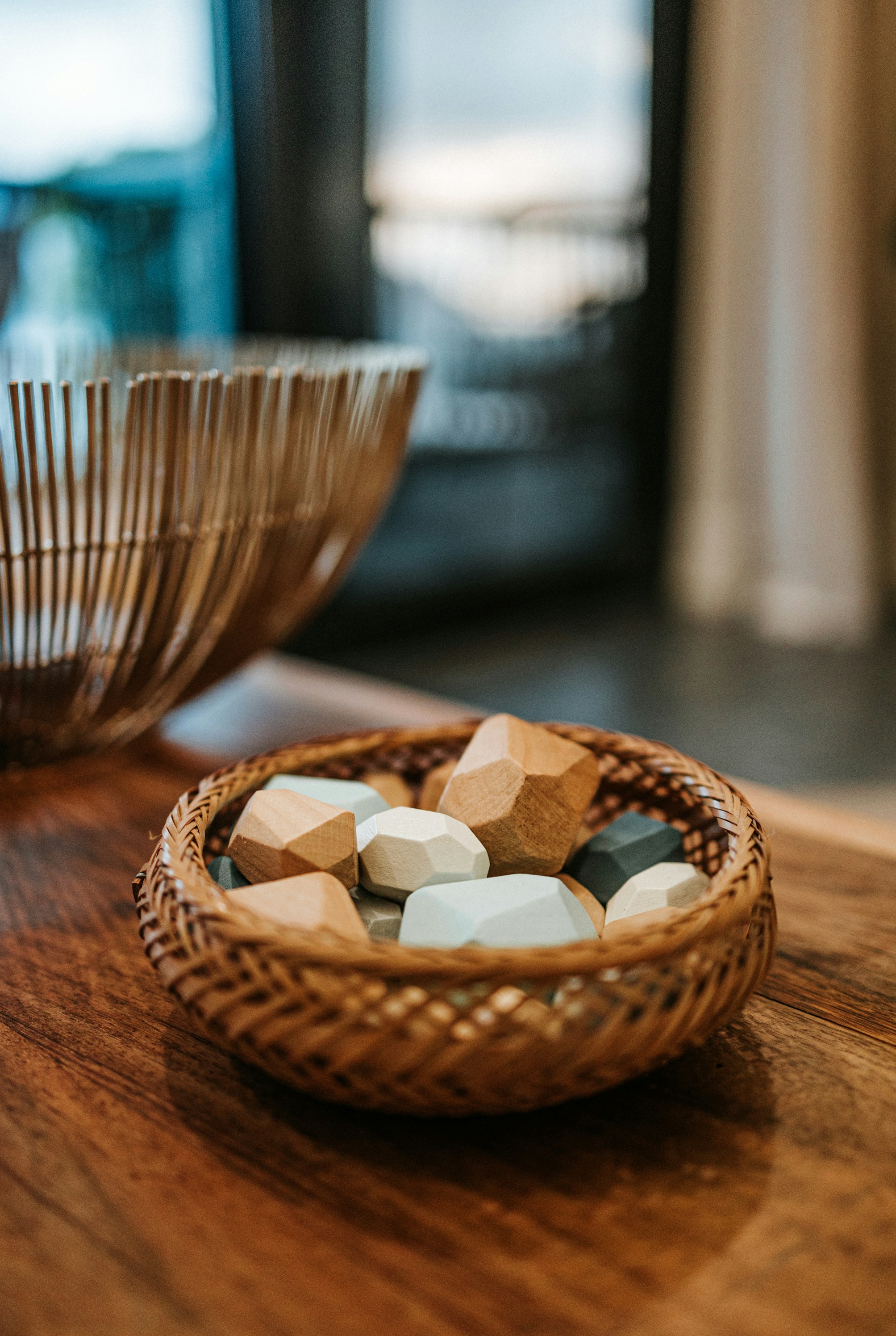 brown woven basket with white and brown stones on brown wooden table