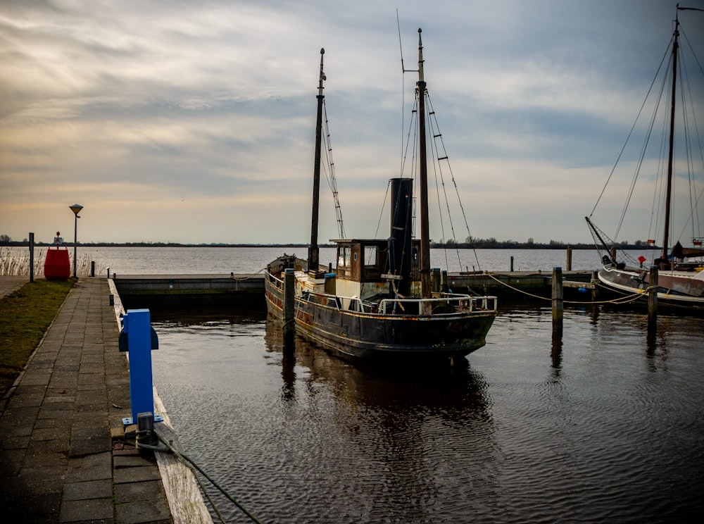 brown and white boat on dock during daytime