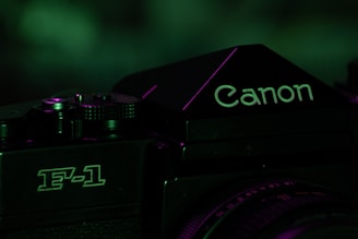A close-up of a vintage camera focusing on the logo and model, with a dark, moody lighting that incorporates green tones.