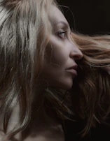 Side profile of a 3D face with realistic hair simulation reflecting a modern bob cut.