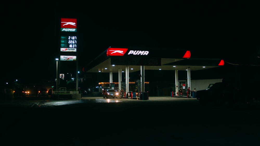 black car parked in front of store during night time