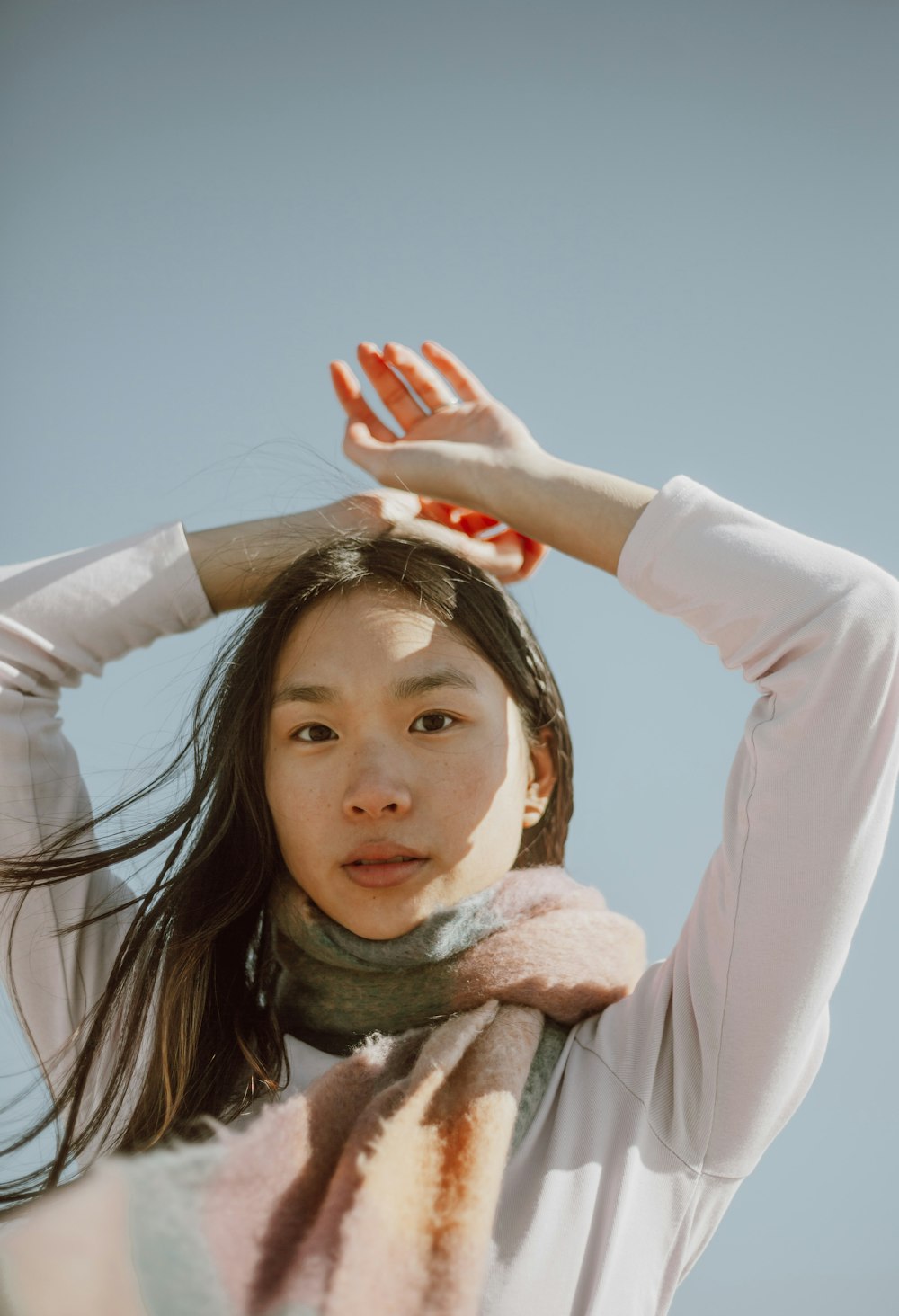 woman in white long sleeve shirt with brown scarf