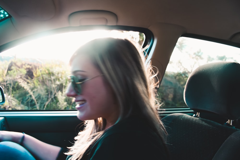 woman in black shirt sitting inside car