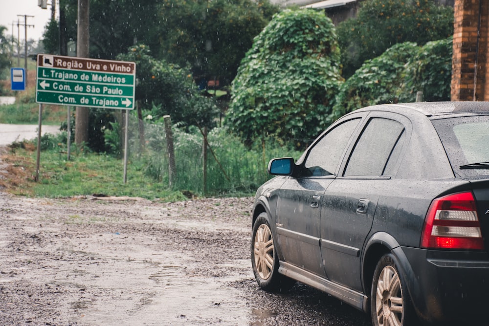 black suv parked on dirt road during daytime