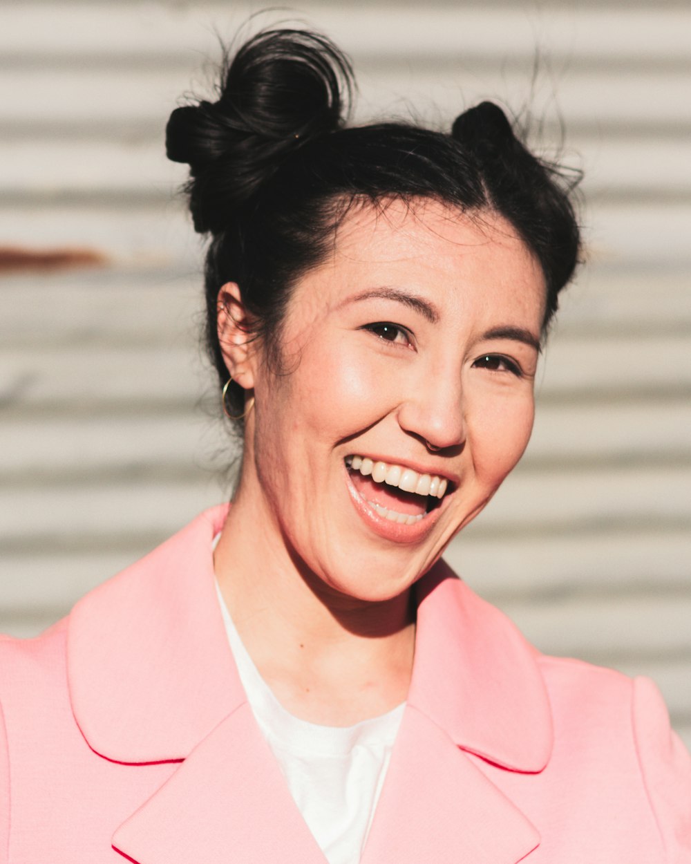 woman in pink blazer smiling