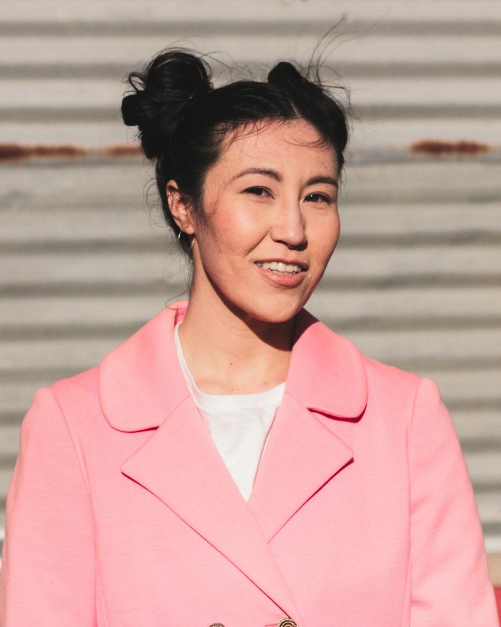 woman in pink blazer smiling