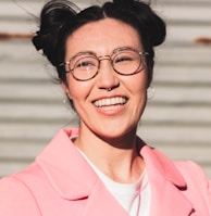 woman in pink blazer smiling