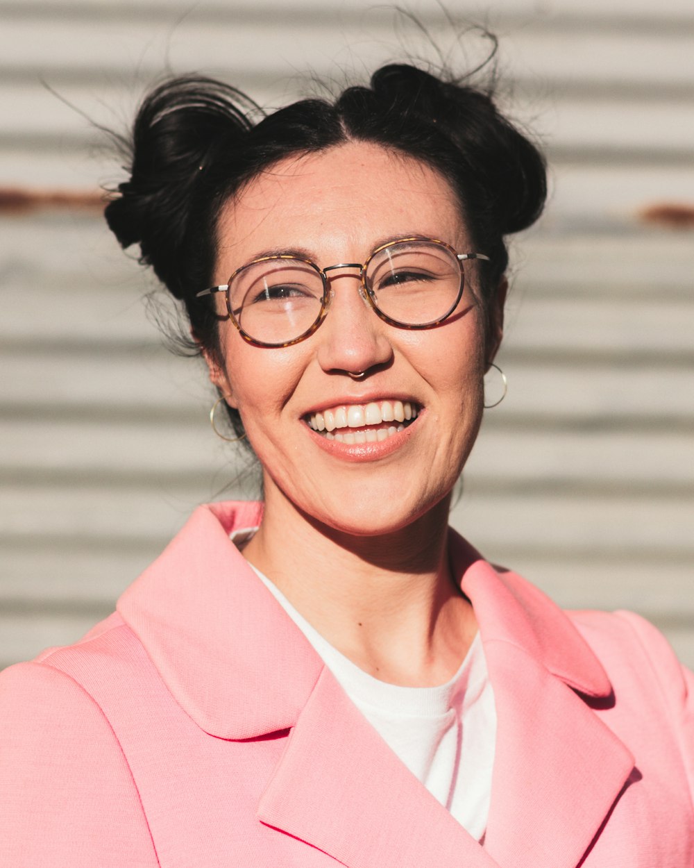 woman in pink blazer smiling