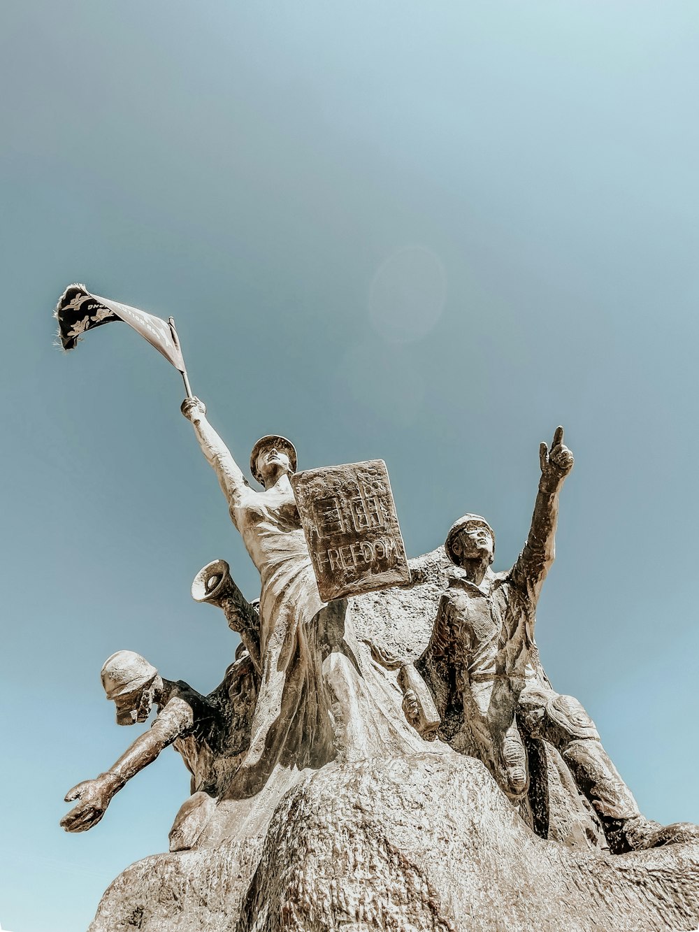 angel holding book statue during daytime