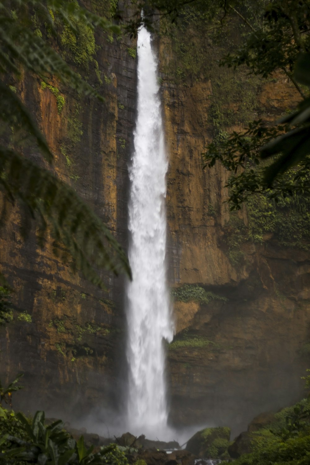 waterfalls on brown rocky mountain during daytime