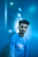 A contemplative figure sitting in meditation surrounded by soft blue and white light.