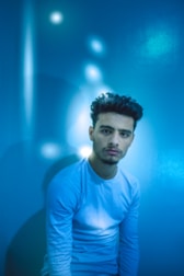 Calm blue-toned illustration of a person reflecting with technology in harmony.