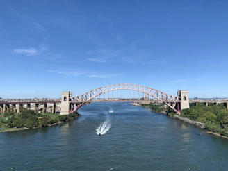 white bridge over river under blue sky during daytime