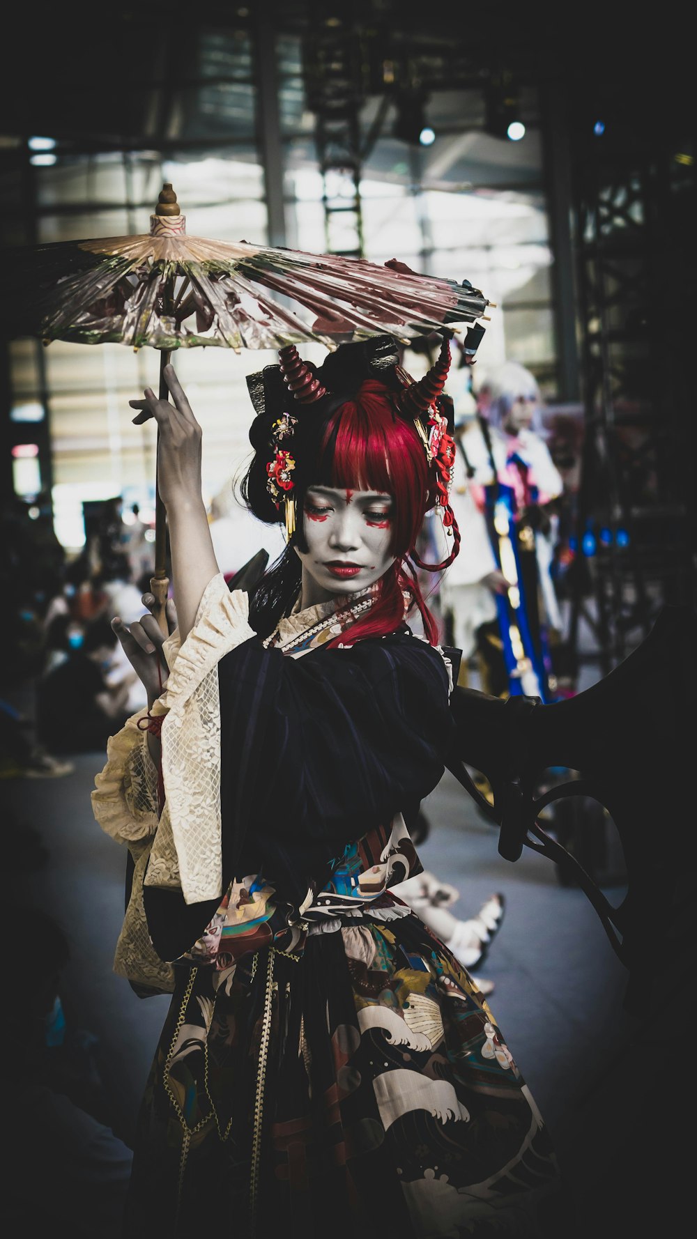 woman in black and red dress holding umbrella