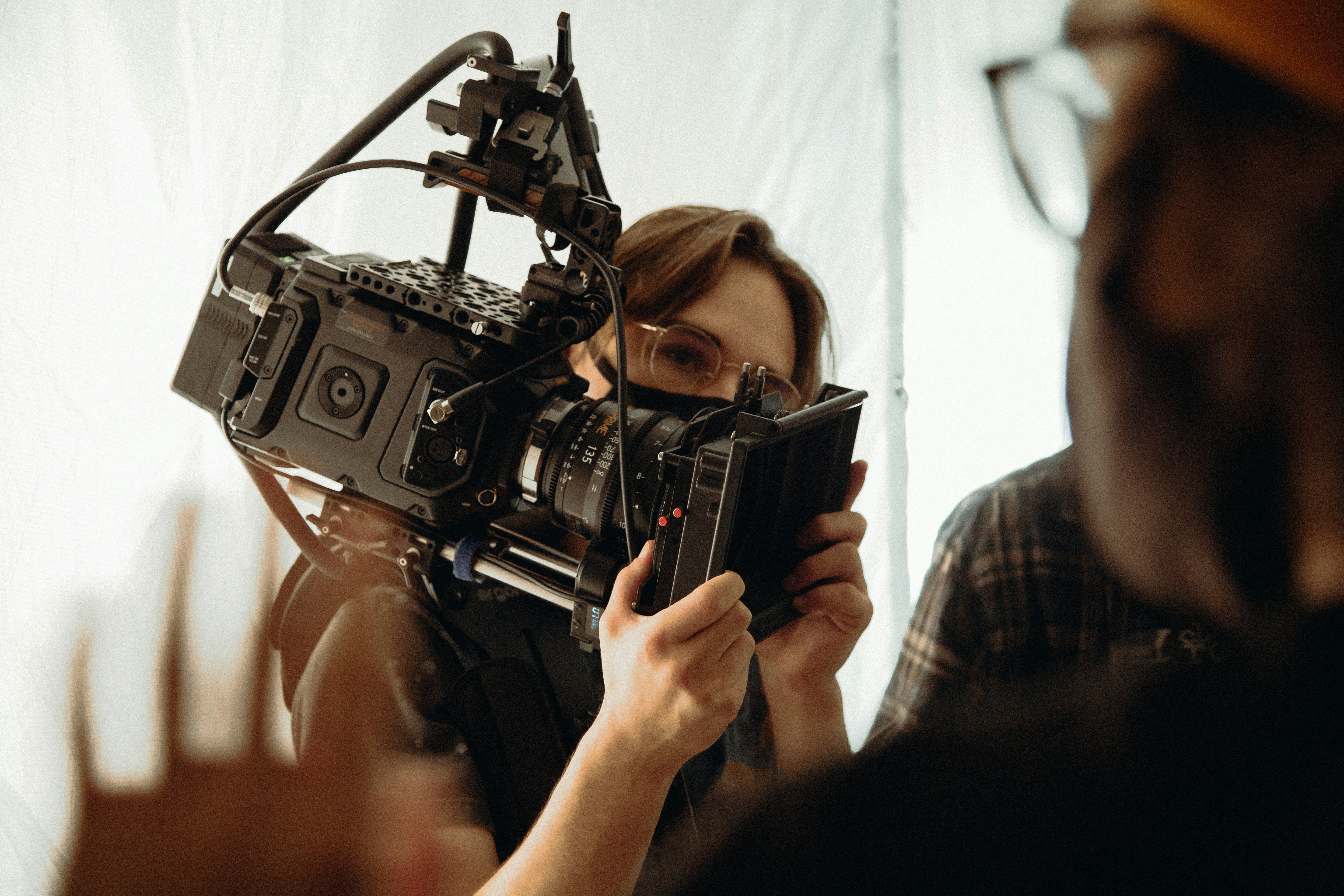 woman holding black dslr camera