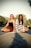 2 women sitting on concrete pavement during daytime