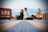 man and woman sitting on brown wooden floor during daytime