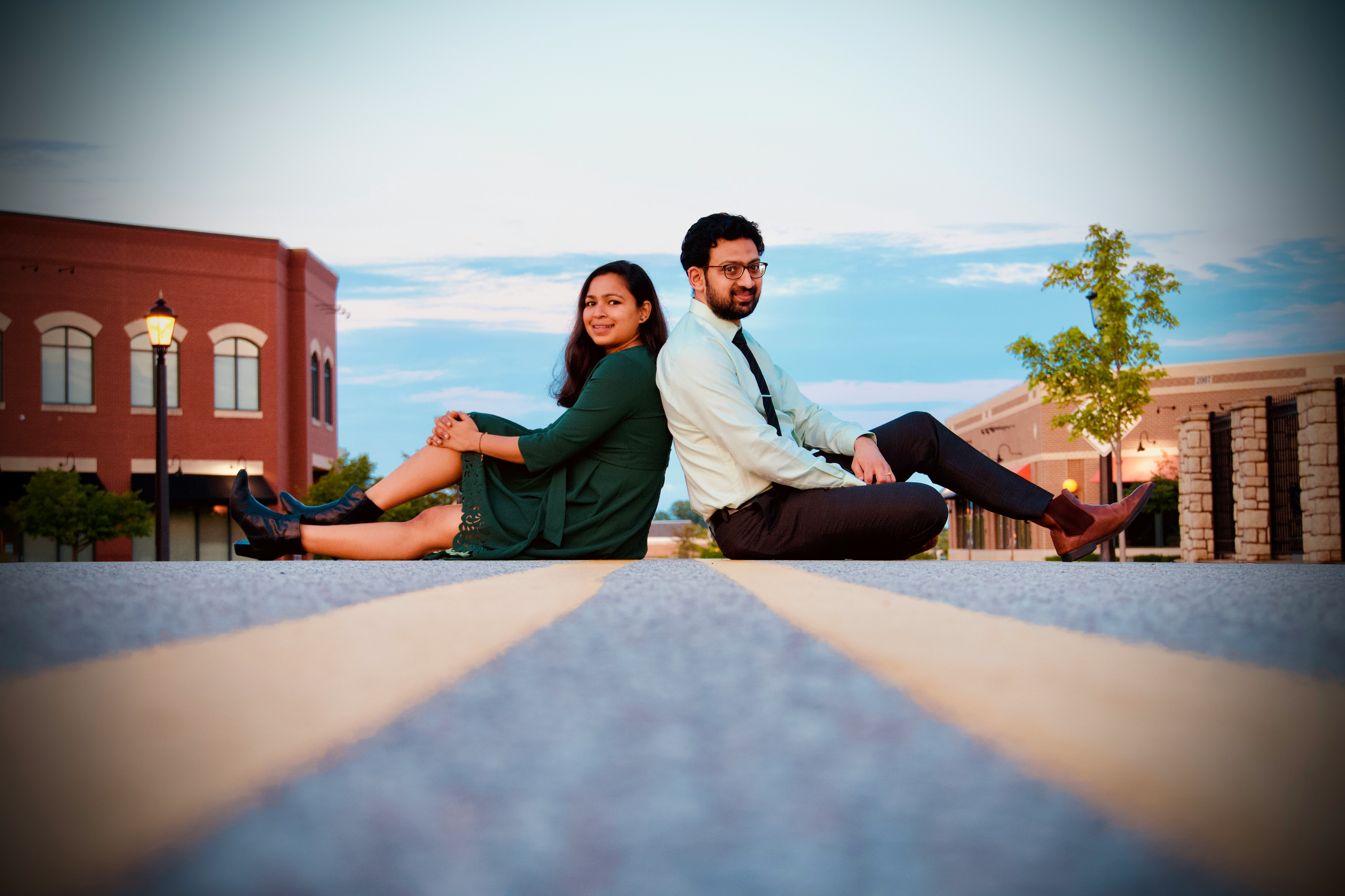 man and woman sitting on brown wooden floor during daytime