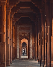 person in black shirt walking on hallway