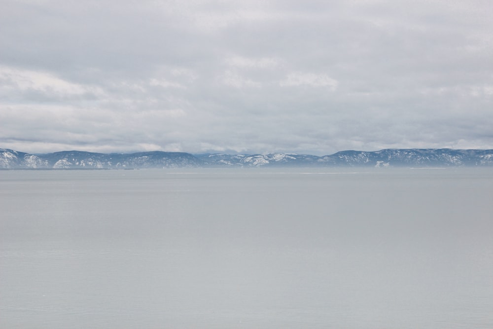 snow covered mountains under cloudy sky during daytime