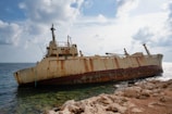white and brown ship on sea under white clouds during daytime