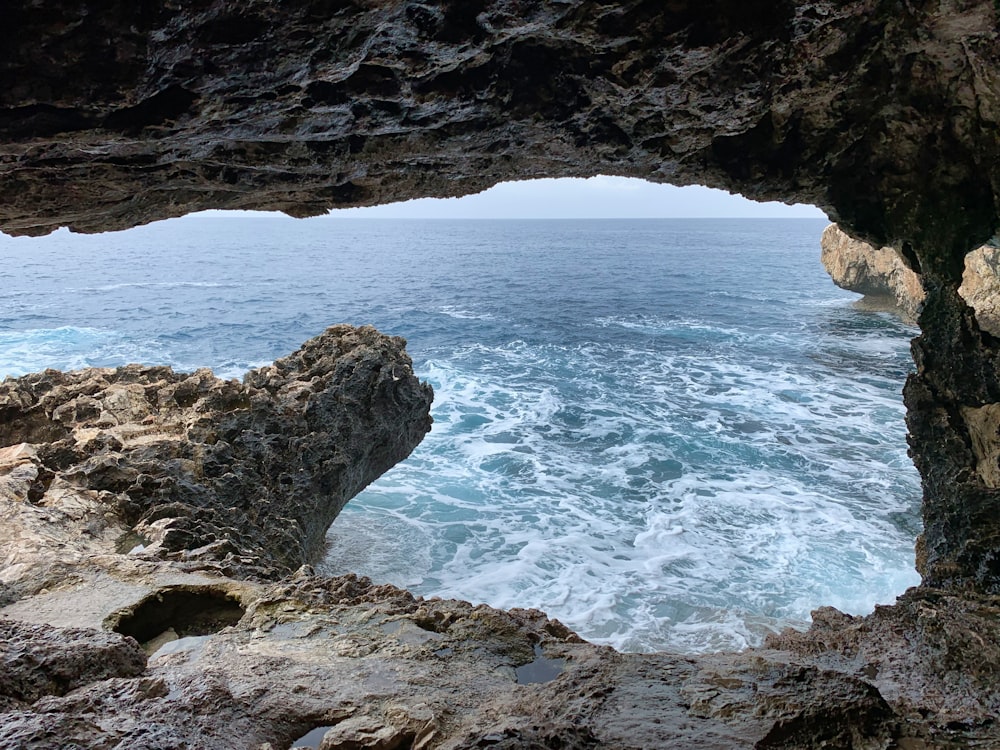 brown rock formation near body of water during daytime