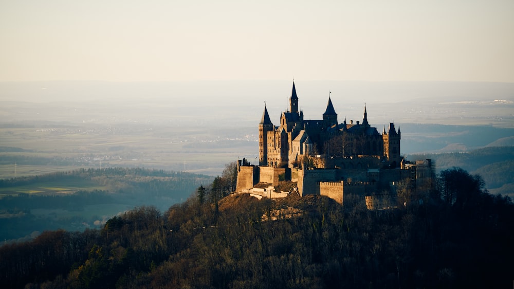 brown castle on top of mountain