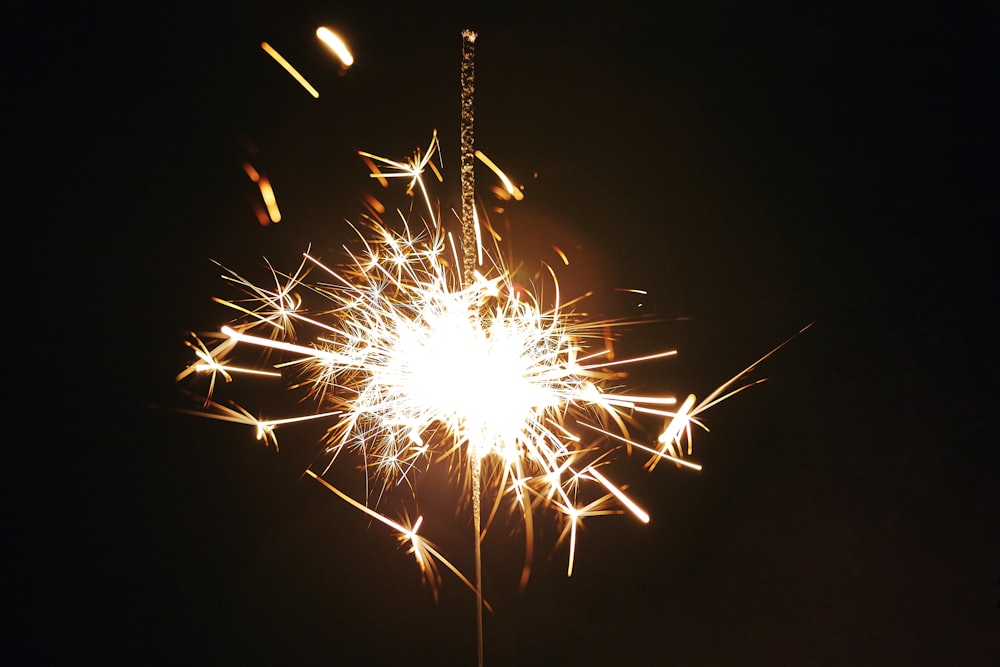 white and red fireworks in dark night sky