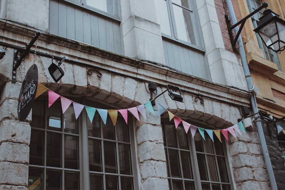 multi colored umbrella on brown brick building