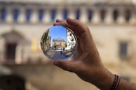 person holding clear glass ball