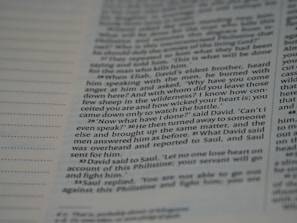 A close-up view of a page from a book, featuring text that includes dialogue and narrative. The text is written in a structured format with numbered paragraphs, suggesting it may be from a religious or historical text.
