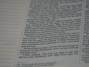 A close-up view of a page from a book, featuring text that includes dialogue and narrative. The text is written in a structured format with numbered paragraphs, suggesting it may be from a religious or historical text.